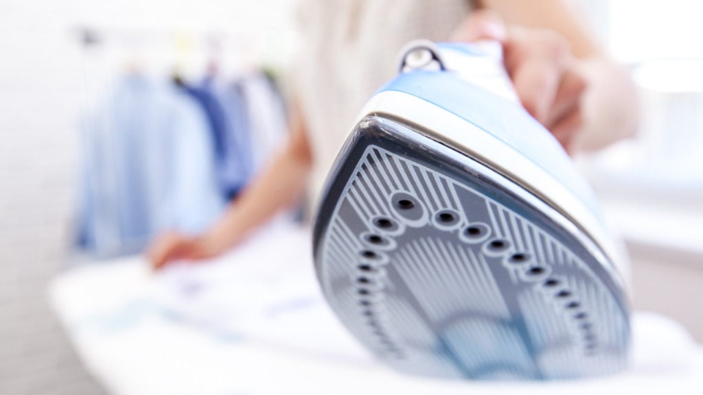Close up hand of woman ironing clothes on the table picture id635872218