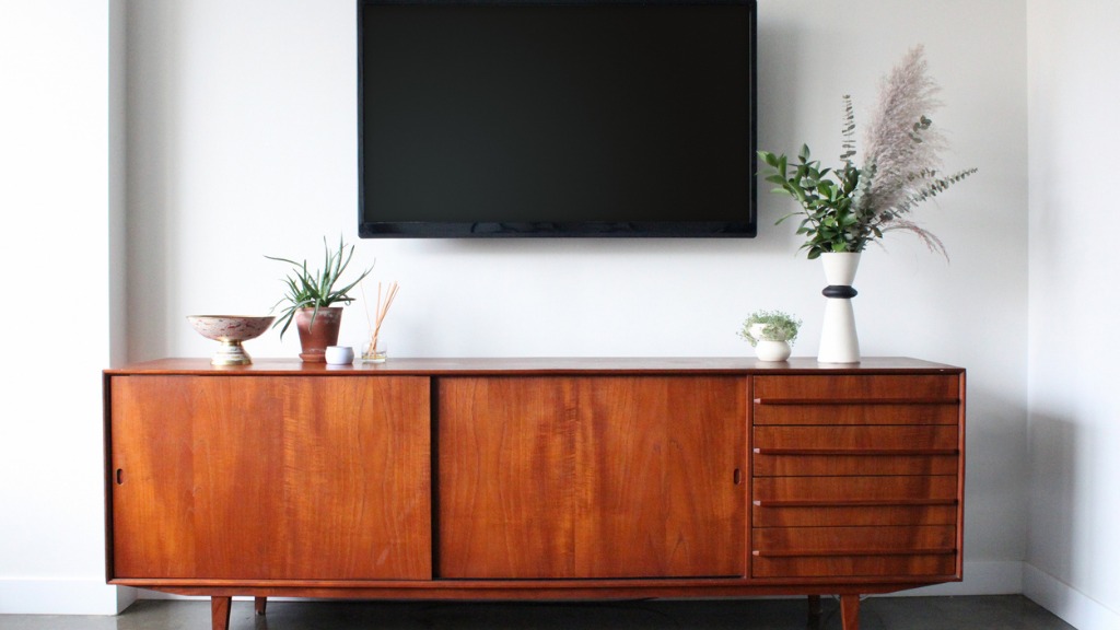 Wall mounted tv in mid century modern furnished apartment picture id856411420
